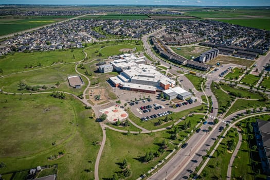 Elevated panorama of Willowgrove, showcasing the neighborhood's modern aesthetics intertwined with pockets of lush green, epitomizing Saskatoon's suburban beauty
