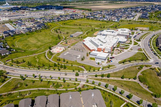 Aerial image of Willowgrove, Saskatoon, SK, showcasing its modern homes, intricate pathways, and lush parks. A neighborhood echoing family-centric living. Ideal for urban planning and real estate.