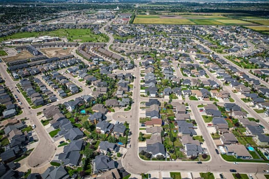 Elevated panorama of Willowgrove, showcasing the neighborhood's modern aesthetics intertwined with pockets of lush green, epitomizing Saskatoon's suburban beauty