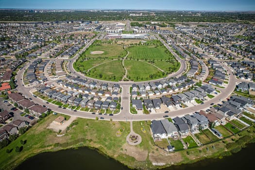 Captivating aerial shot of Stonebridge in Saskatoon, highlighting the harmonious blend of modern architecture and Saskatchewan's verdant surroundings.