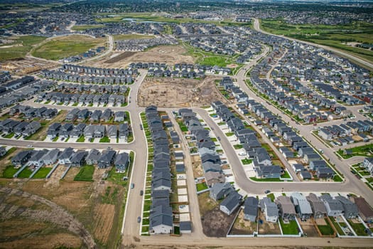 Elevated view of Rosewood neighborhood in Saskatoon, presenting a tapestry of urban design intertwined with Saskatchewan's serene natural canvas.
