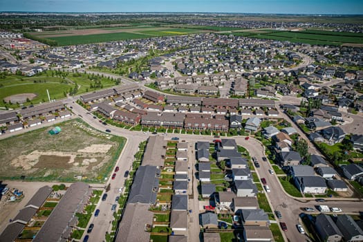 Elevated panorama of Willowgrove, showcasing the neighborhood's modern aesthetics intertwined with pockets of lush green, epitomizing Saskatoon's suburban beauty