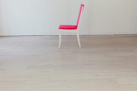pink chair in the interior of an empty room