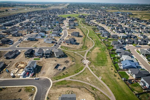 Elevated view of Rosewood neighborhood in Saskatoon, presenting a tapestry of urban design intertwined with Saskatchewan's serene natural canvas.