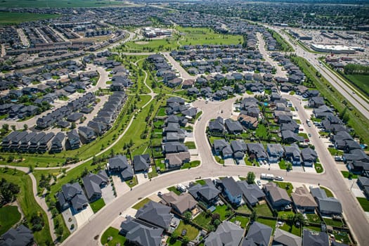 Elevated panorama of Willowgrove, showcasing the neighborhood's modern aesthetics intertwined with pockets of lush green, epitomizing Saskatoon's suburban beauty