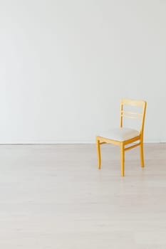 yellow chair in the interior of a white empty room