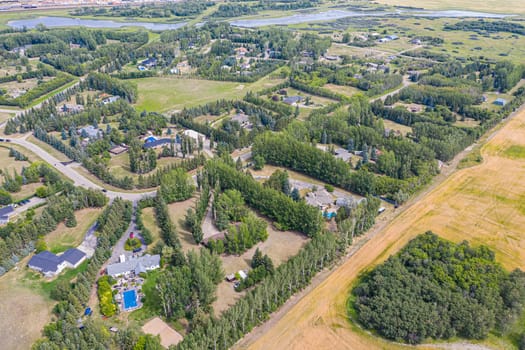 Experience the charm of Cedar Villa Estates from above. This drone image beautifully showcases the area's spacious estates, lush greenery, and tranquil setting, offering a unique aerial perspective of Saskatoon.
