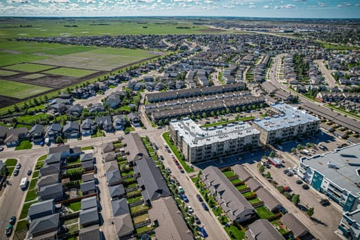 Elevated panorama of Willowgrove, showcasing the neighborhood's modern aesthetics intertwined with pockets of lush green, epitomizing Saskatoon's suburban beauty
