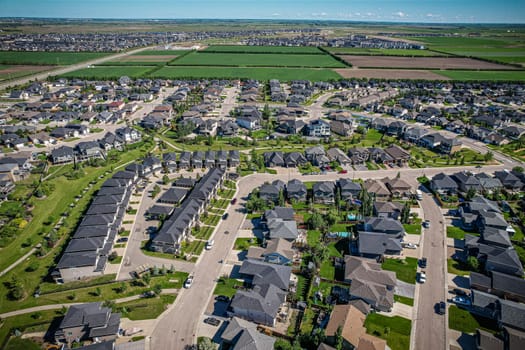 Elevated panorama of Willowgrove, showcasing the neighborhood's modern aesthetics intertwined with pockets of lush green, epitomizing Saskatoon's suburban beauty