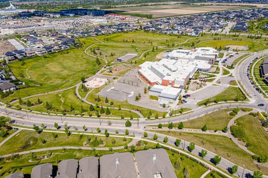 Aerial image of Willowgrove, Saskatoon, SK, showcasing its modern homes, intricate pathways, and lush parks. A neighborhood echoing family-centric living. Ideal for urban planning and real estate.