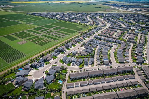 Elevated panorama of Willowgrove, showcasing the neighborhood's modern aesthetics intertwined with pockets of lush green, epitomizing Saskatoon's suburban beauty