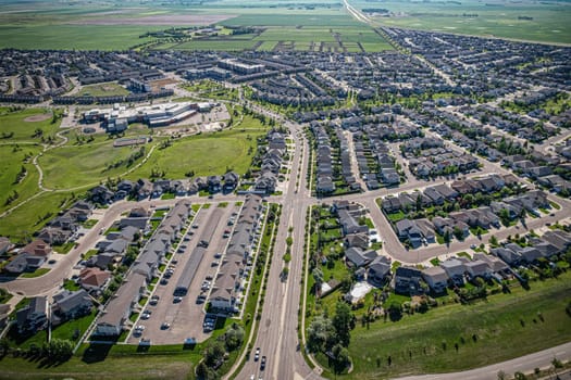 Elevated panorama of Willowgrove, showcasing the neighborhood's modern aesthetics intertwined with pockets of lush green, epitomizing Saskatoon's suburban beauty