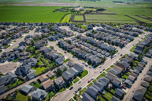 Elevated panorama of Willowgrove, showcasing the neighborhood's modern aesthetics intertwined with pockets of lush green, epitomizing Saskatoon's suburban beauty