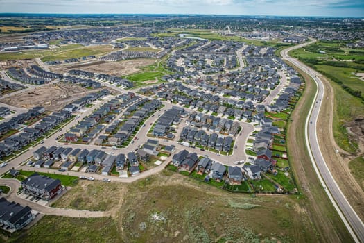 Elevated view of Rosewood neighborhood in Saskatoon, presenting a tapestry of urban design intertwined with Saskatchewan's serene natural canvas.