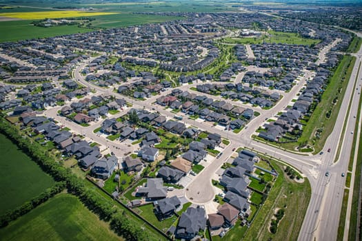 Elevated panorama of Willowgrove, showcasing the neighborhood's modern aesthetics intertwined with pockets of lush green, epitomizing Saskatoon's suburban beauty