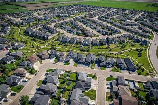 Elevated panorama of Willowgrove, showcasing the neighborhood's modern aesthetics intertwined with pockets of lush green, epitomizing Saskatoon's suburban beauty