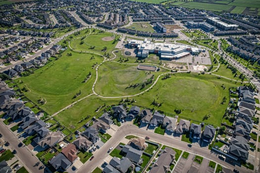 Elevated panorama of Willowgrove, showcasing the neighborhood's modern aesthetics intertwined with pockets of lush green, epitomizing Saskatoon's suburban beauty