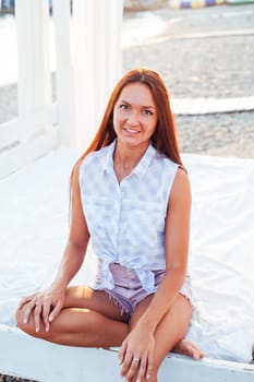 tanned woman portrait at dawn on the beach