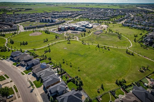 Elevated panorama of Willowgrove, showcasing the neighborhood's modern aesthetics intertwined with pockets of lush green, epitomizing Saskatoon's suburban beauty