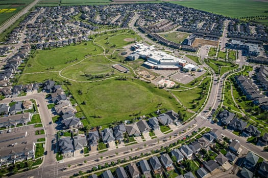 Elevated panorama of Willowgrove, showcasing the neighborhood's modern aesthetics intertwined with pockets of lush green, epitomizing Saskatoon's suburban beauty