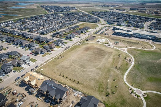 Stunning bird's-eye perspective of the Evergreen neighborhood in Saskatoon, showcasing the unique urban layout and the natural beauty of Saskatchewan's landscapes.