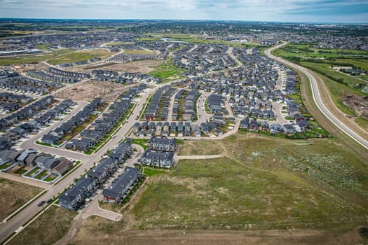 Elevated view of Rosewood neighborhood in Saskatoon, presenting a tapestry of urban design intertwined with Saskatchewan's serene natural canvas.