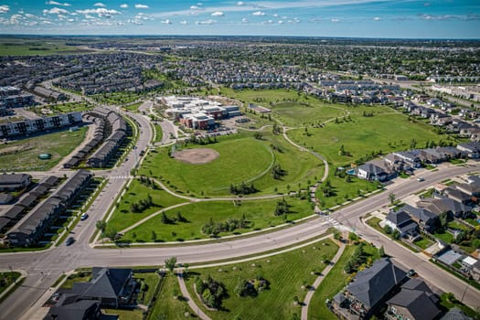 Elevated panorama of Willowgrove, showcasing the neighborhood's modern aesthetics intertwined with pockets of lush green, epitomizing Saskatoon's suburban beauty