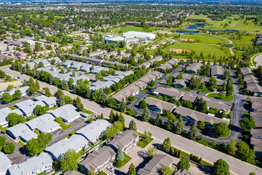 Aerial of Wildwood, Saskatoon, SK, highlighting its parks, diverse homes, and vibrant community life. A suburban haven reflecting harmonious living, perfect for real estate and urban design visuals.
