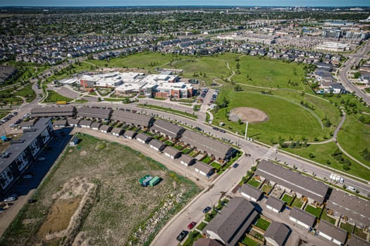 Elevated panorama of Willowgrove, showcasing the neighborhood's modern aesthetics intertwined with pockets of lush green, epitomizing Saskatoon's suburban beauty