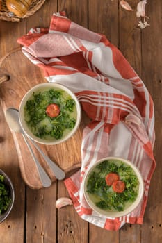 Caldo verde popular soup in Portuguese cuisine. traditional ingredients for caldo verde are potatoes, collard greens , olive oil and salt. Additionally garlic or onion may be added.