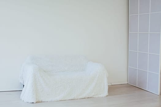 white sofa in the interior of an empty room