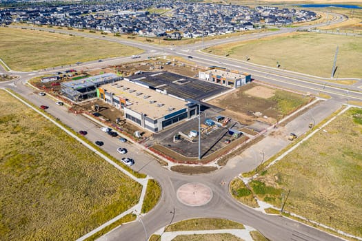 Aerial image of Evergreen, Saskatoon, SK, highlighting tree-lined streets, modern homes, and green spaces. A serene neighborhood portrait, ideal for real estate and urban planning.