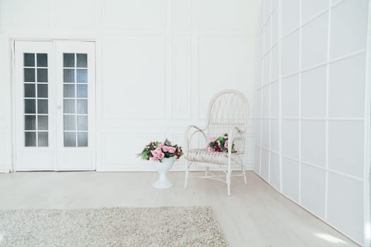 white vintage chair with flowers in the interior of the room