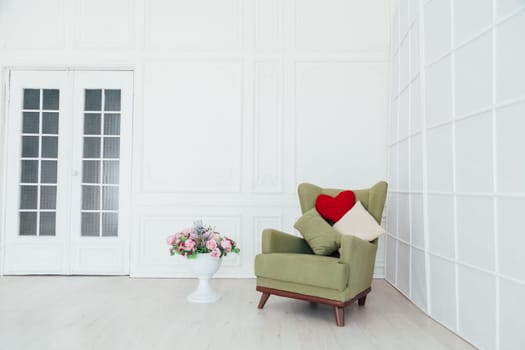 green chair in the interior of the white room