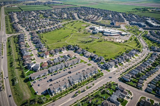 Elevated panorama of Willowgrove, showcasing the neighborhood's modern aesthetics intertwined with pockets of lush green, epitomizing Saskatoon's suburban beauty