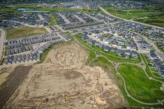 Elevated view of Rosewood neighborhood in Saskatoon, presenting a tapestry of urban design intertwined with Saskatchewan's serene natural canvas.