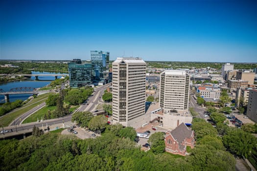 Aerial spectacle of downtown Saskatoon, revealing the city's architectural marvels, bustling streets, and the pulsating core of Saskatchewan's metropolis