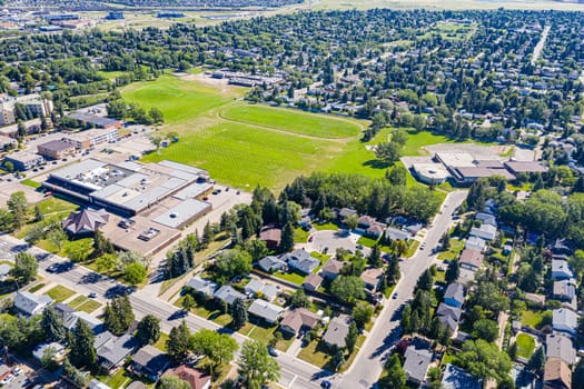 Explore College Park in Saskatoon from an aerial view. This drone image captures the neighborhood's blend of educational facilities, residential areas, and verdant parks, showcasing its dynamic urban fabric.
