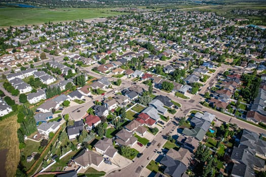 Aerial journey over Silverspring in Saskatoon, revealing a harmonious blend of suburban life, green expanses, and the distinct charm of Saskatchewan's landscapes.