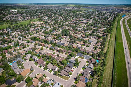 Soaring over Lakeview in Saskatoon, this bird's-eye capture magnifies the neighborhood's tranquil waters, verdant parks, and the serene rhythm of Saskatchewan living