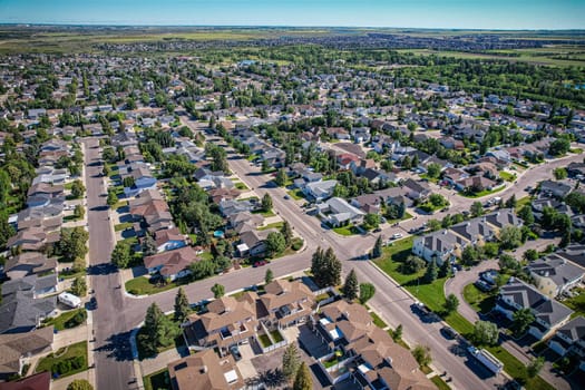 Aerial journey over Silverspring in Saskatoon, revealing a harmonious blend of suburban life, green expanses, and the distinct charm of Saskatchewan's landscapes.