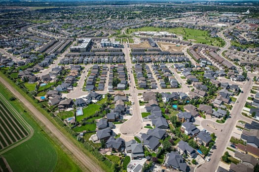 Elevated panorama of Willowgrove, showcasing the neighborhood's modern aesthetics intertwined with pockets of lush green, epitomizing Saskatoon's suburban beauty