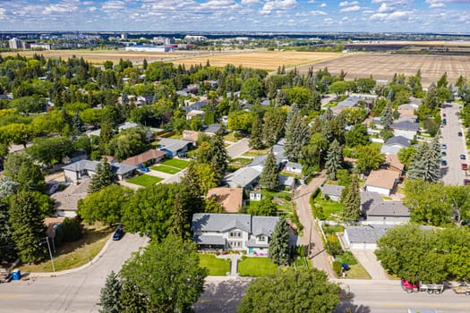 Experience the charm of Greystone Heights in Saskatoon from the sky. This drone image beautifully captures the neighborhood's serene streets, lush parks, and the cohesive community atmosphere.
