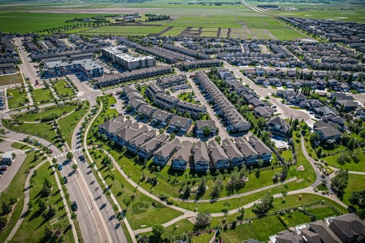 Elevated panorama of Willowgrove, showcasing the neighborhood's modern aesthetics intertwined with pockets of lush green, epitomizing Saskatoon's suburban beauty