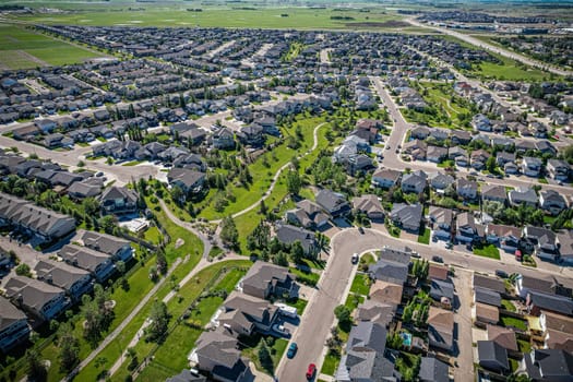 Elevated panorama of Willowgrove, showcasing the neighborhood's modern aesthetics intertwined with pockets of lush green, epitomizing Saskatoon's suburban beauty