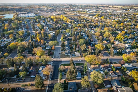 Soaring over Lakeview in Saskatoon, this bird's-eye capture magnifies the neighborhood's tranquil waters, verdant parks, and the serene rhythm of Saskatchewan living