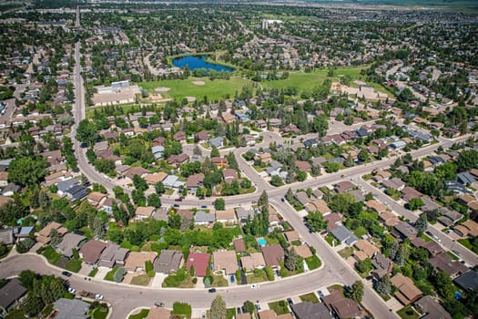 Soaring over Lakeview in Saskatoon, this bird's-eye capture magnifies the neighborhood's tranquil waters, verdant parks, and the serene rhythm of Saskatchewan living