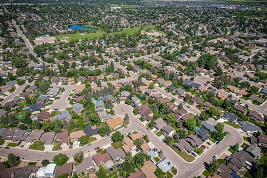Soaring over Lakeview in Saskatoon, this bird's-eye capture magnifies the neighborhood's tranquil waters, verdant parks, and the serene rhythm of Saskatchewan living