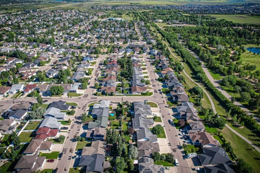 Aerial journey over Silverspring in Saskatoon, revealing a harmonious blend of suburban life, green expanses, and the distinct charm of Saskatchewan's landscapes.