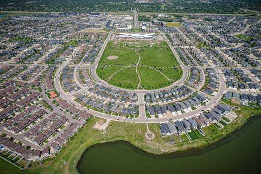 Captivating aerial shot of Stonebridge in Saskatoon, highlighting the harmonious blend of modern architecture and Saskatchewan's verdant surroundings.